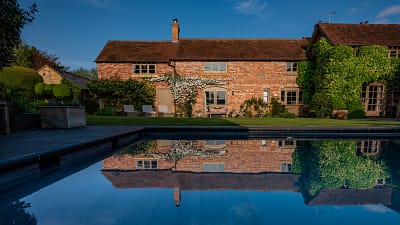 Pool reflection lower farm house with pool near wilderness festival
